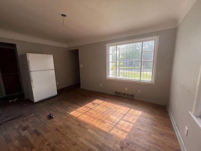 3501 Fleming Rd, Flint, MI 48504 - unfurnished bedroom featuring freestanding refrigerator and wood-type flooring