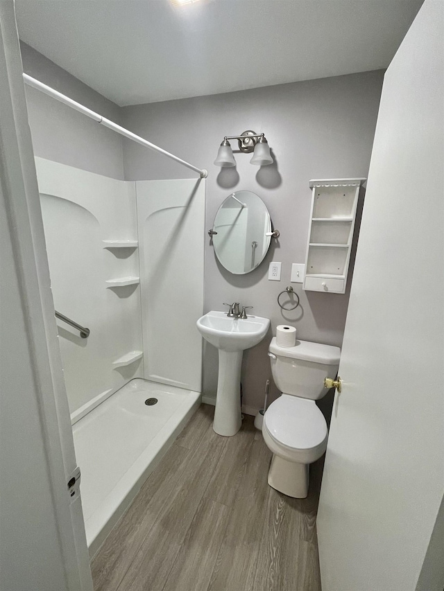301 W State St, Corunna, MI 48817 - full bathroom featuring a stall shower and wood finished floors