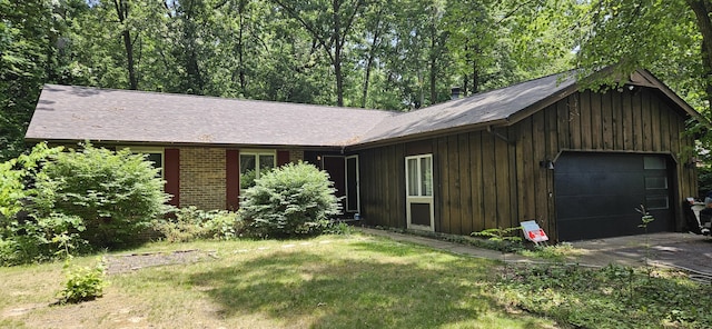 219 Walnut Woods Ct, Plainwell, MI 49080 - view of front facade with driveway, board and batten siding, and a front yard
