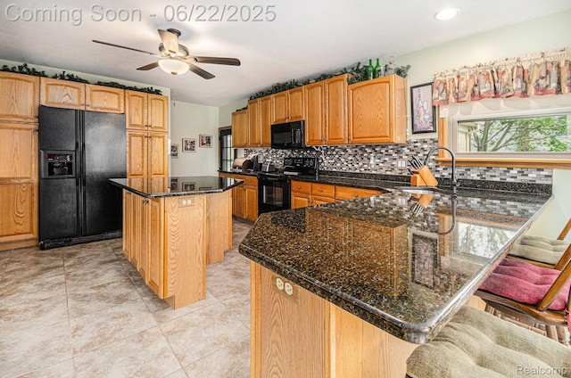 9300 Clippert St, Taylor, MI 48180 - kitchen with black appliances, decorative backsplash, ceiling fan, a peninsula, and a breakfast bar