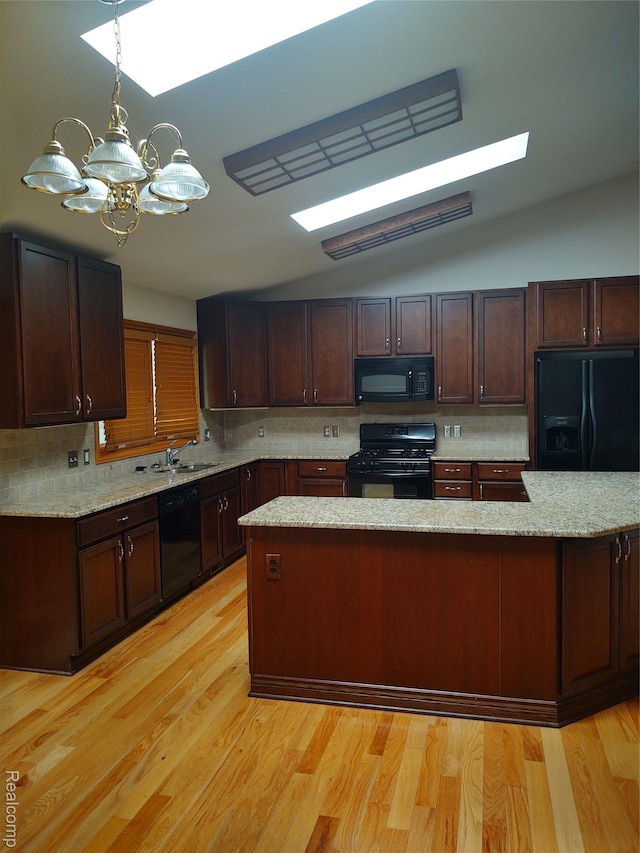 8996 Main St, Whitmore Lake, MI 48189 - kitchen with black appliances, a chandelier, tasteful backsplash, decorative light fixtures, and vaulted ceiling