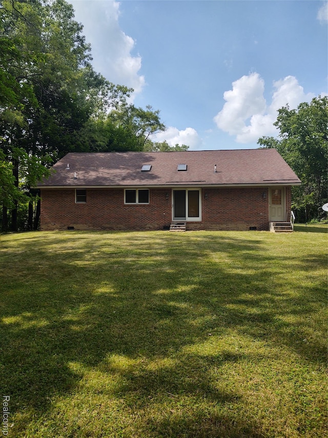 8996 Main St, Whitmore Lake, MI 48189 - back of property featuring entry steps, a yard, brick siding, and crawl space