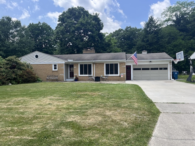 4340 Sunset Dr, Kalamazoo, MI 49008 - single story home with a chimney, a garage, brick siding, driveway, and a front lawn