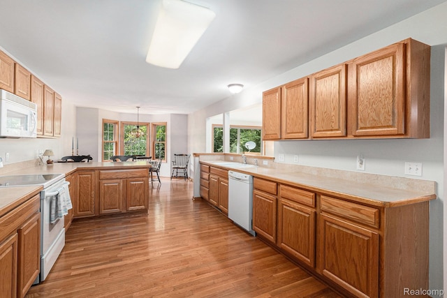 6144 Northridge Hills Dr, Brighton, MI 48116 - kitchen with white appliances, a peninsula, light wood-style floors, and light countertops