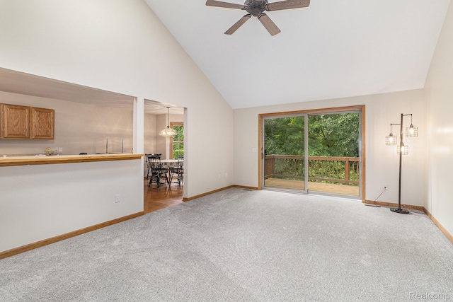 6144 Northridge Hills Dr, Brighton, MI 48116 - unfurnished living room featuring carpet flooring, healthy amount of natural light, high vaulted ceiling, and ceiling fan