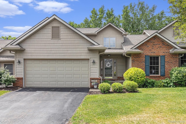 6144 Northridge Hills Dr, Brighton, MI 48116 - view of front of home with brick siding, asphalt driveway, roof with shingles, a front yard, and an attached garage
