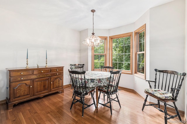 6144 Northridge Hills Dr, Brighton, MI 48116 - dining area with a chandelier and light wood-type flooring