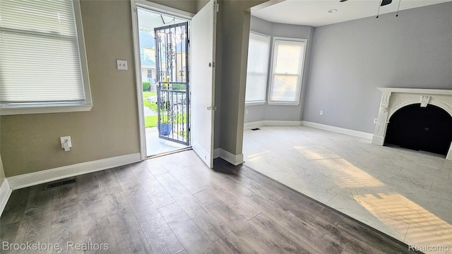 2520 Seyburn St, Detroit, MI 48214 - unfurnished living room with wood finished floors, a ceiling fan, and a fireplace