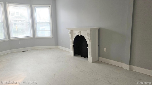 2520 Seyburn St, Detroit, MI 48214 - unfurnished living room featuring light marble finish flooring and healthy amount of natural light