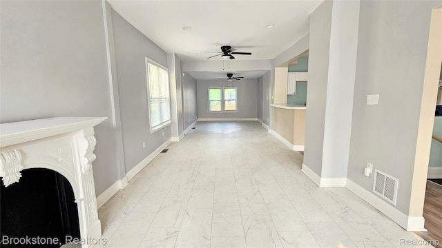 2520 Seyburn St, Detroit, MI 48214 - unfurnished living room featuring light marble finish flooring, a ceiling fan, and a fireplace