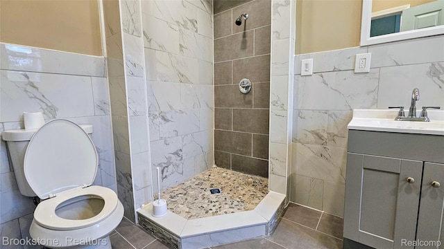 2520 Seyburn St, Detroit, MI 48214 - bathroom with tile walls, a tile shower, vanity, and tile patterned flooring
