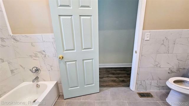 2520 Seyburn St, Detroit, MI 48214 - full bath with tile walls, a bath, and tile patterned flooring