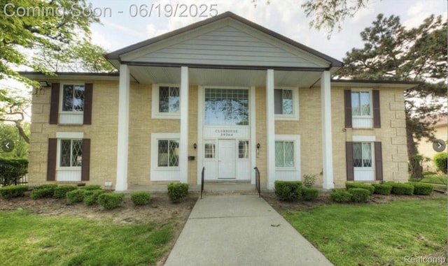 29264 Gloede Dr, Warren, MI 48088 - neoclassical / greek revival house featuring a front yard and brick siding