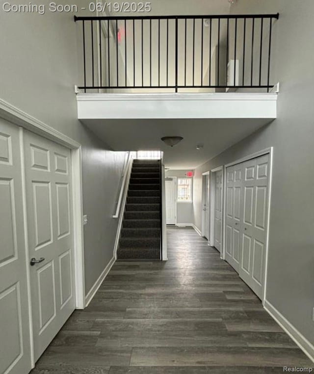 29264 Gloede Dr, Warren, MI 48088 - hall with stairs, dark wood-style floors, and a towering ceiling