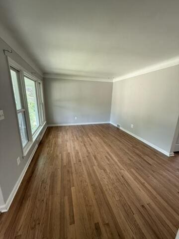 22026 Alger St, Saint Clair Shores, MI 48080 - unfurnished living room featuring dark wood-type flooring and crown molding