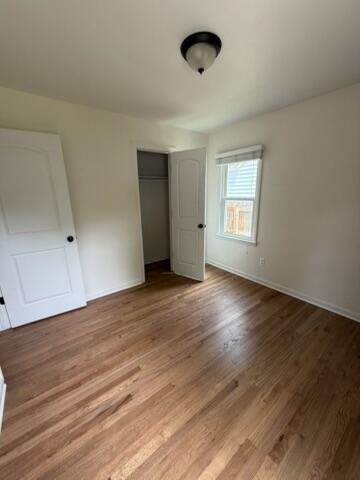 22026 Alger St, Saint Clair Shores, MI 48080 - unfurnished bedroom featuring a closet and wood finished floors