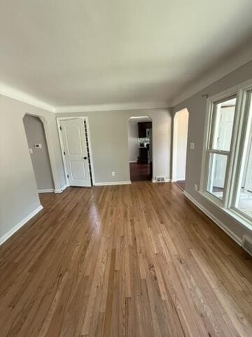 22026 Alger St, Saint Clair Shores, MI 48080 - unfurnished living room with arched walkways and wood finished floors