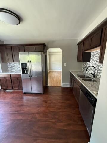 22026 Alger St, Saint Clair Shores, MI 48080 - kitchen with stainless steel appliances, decorative backsplash, light countertops, and dark wood-style floors