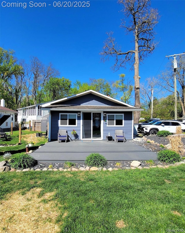 11329 E Shore Dr, Whitmore Lake, MI 48189 - view of front of home with a wooden deck and a front yard