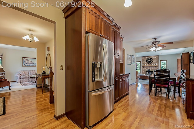 24320 Simmons Dr, Novi, MI 48374 - kitchen with stainless steel fridge, light wood finished floors, a ceiling fan, a chandelier, and open floor plan