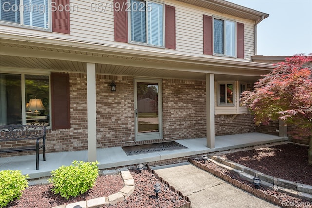 24320 Simmons Dr, Novi, MI 48374 - property entrance featuring a porch and brick siding