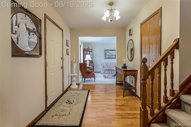 24320 Simmons Dr, Novi, MI 48374 - foyer with a chandelier, stairway, and light wood-style floors