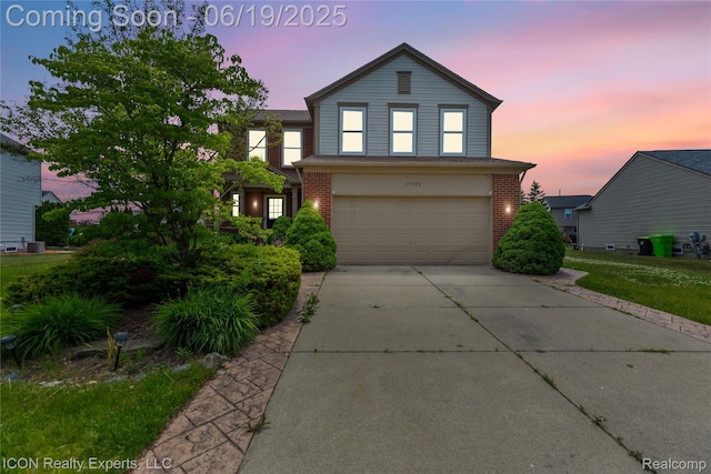 17922 Wingate Dr, Macomb, MI 48042 - traditional-style home featuring an attached garage, brick siding, and driveway