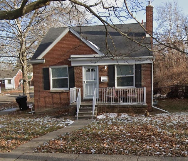 9424 Sanilac St, Detroit, MI 48224 - bungalow-style house with a chimney, brick siding, a porch, and a shingled roof
