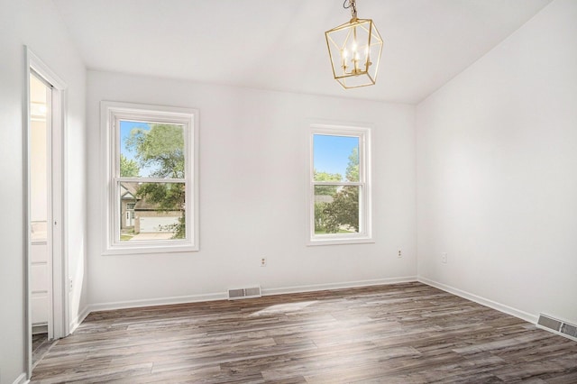 2502 Thorn Creek St SE, Kentwood, MI 49508 - unfurnished room featuring healthy amount of natural light, wood finished floors, and a chandelier