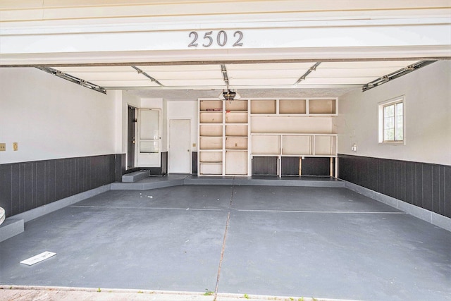 2502 Thorn Creek St SE, Kentwood, MI 49508 - garage featuring a wainscoted wall and a garage door opener