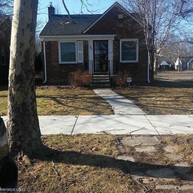 9327 Camley St, Detroit, MI 48224 - bungalow-style house featuring brick siding and a chimney