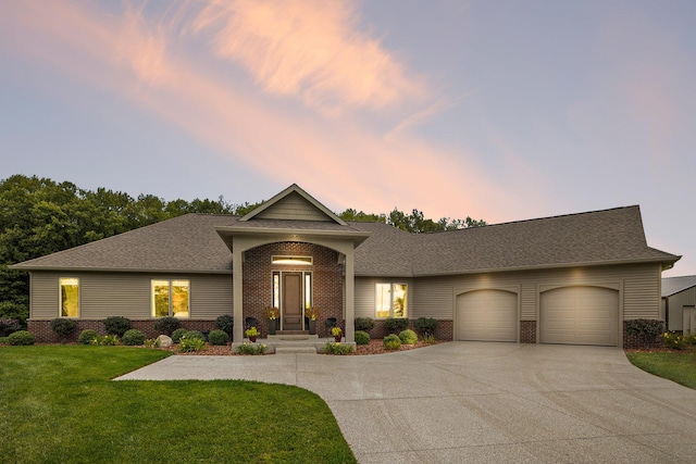 68363 Calvin Center Rd, Cassopolis, MI 49031 - view of front facade with brick siding, an attached garage, driveway, a lawn, and a shingled roof
