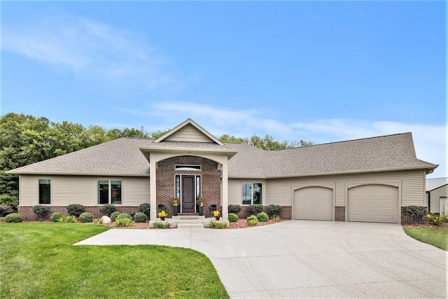 68363 Calvin Center Rd, Cassopolis, MI 49031 - view of front of house featuring brick siding, a garage, driveway, a front yard, and a shingled roof