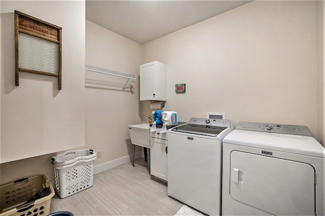 68363 Calvin Center Rd, Cassopolis, MI 49031 - washroom featuring separate washer and dryer and cabinet space
