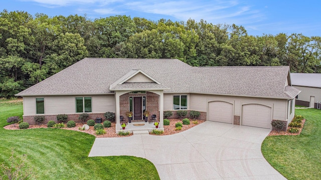 68363 Calvin Center Rd, Cassopolis, MI 49031 - view of front of property featuring a garage, brick siding, concrete driveway, a shingled roof, and a front lawn
