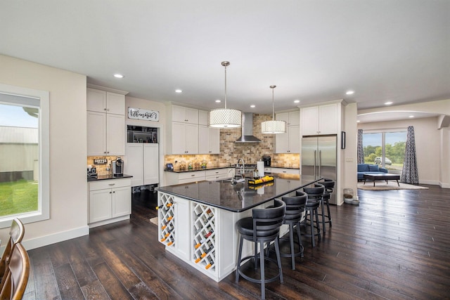 68363 Calvin Center Rd, Cassopolis, MI 49031 - kitchen with stainless steel built in fridge, dark countertops, dark wood finished floors, recessed lighting, and wall chimney exhaust hood