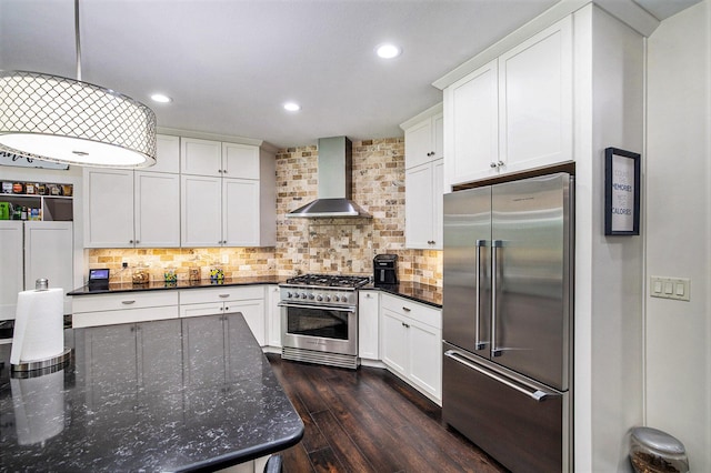 68363 Calvin Center Rd, Cassopolis, MI 49031 - kitchen with premium appliances, wall chimney range hood, dark wood-type flooring, white cabinets, and decorative backsplash