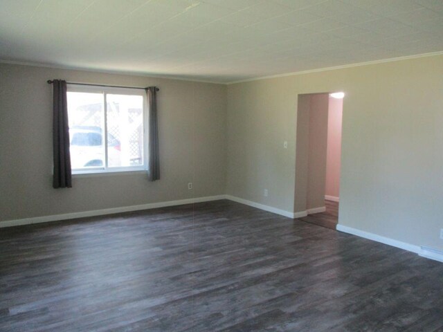 307 John St, Colon, MI 49040 - unfurnished room featuring crown molding and dark wood-type flooring