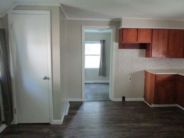 307 John St, Colon, MI 49040 - kitchen featuring dark wood finished floors, brown cabinets, backsplash, and light countertops