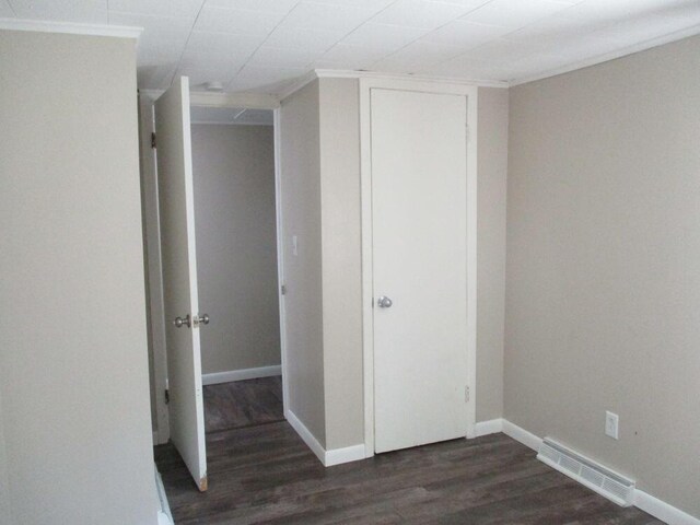307 John St, Colon, MI 49040 - unfurnished bedroom with dark wood-style flooring and a closet