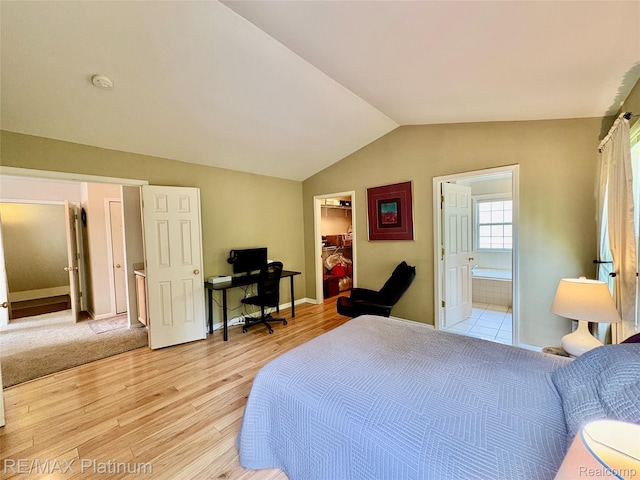 5089 Northfield Dr, Howell, MI 48843 - bedroom featuring light wood finished floors, a spacious closet, lofted ceiling, ensuite bathroom, and a closet