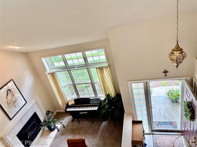 5089 Northfield Dr, Howell, MI 48843 - carpeted entryway featuring a tiled fireplace