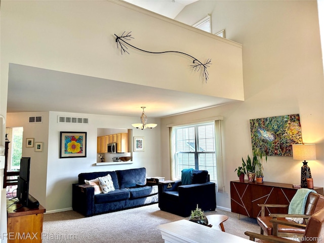 5089 Northfield Dr, Howell, MI 48843 - carpeted living area with a chandelier and a high ceiling