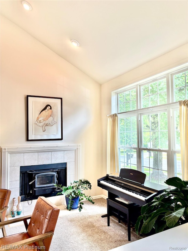 5089 Northfield Dr, Howell, MI 48843 - living area featuring vaulted ceiling, carpet floors, and a tile fireplace