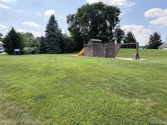 5089 Northfield Dr, Howell, MI 48843 - view of green lawn with a playground