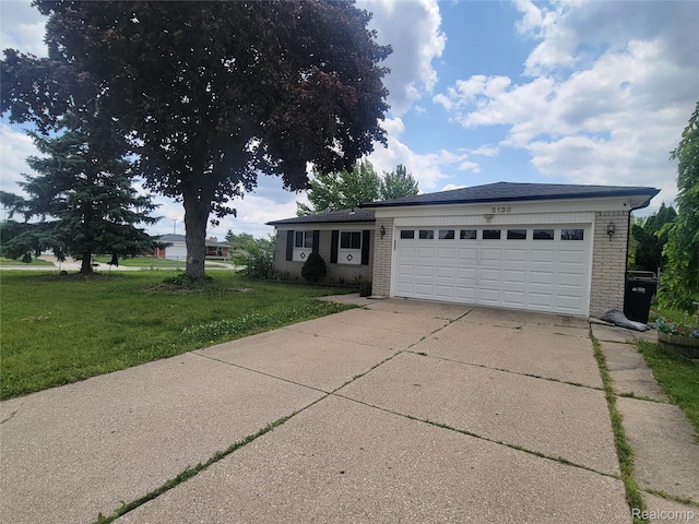 3136 Alden Dr, Sterling Heights, MI 48310 - view of front of property with brick siding, a front lawn, an attached garage, and driveway