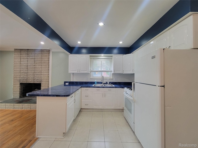 3136 Alden Dr, Sterling Heights, MI 48310 - kitchen with white appliances, a peninsula, white cabinetry, dark countertops, and recessed lighting