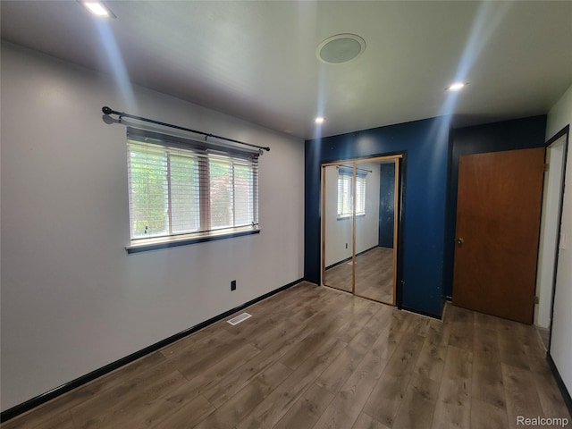 3136 Alden Dr, Sterling Heights, MI 48310 - unfurnished bedroom with wood finished floors and a closet