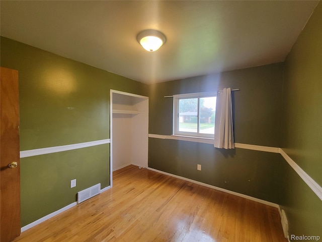 3136 Alden Dr, Sterling Heights, MI 48310 - unfurnished bedroom featuring wood finished floors and a closet