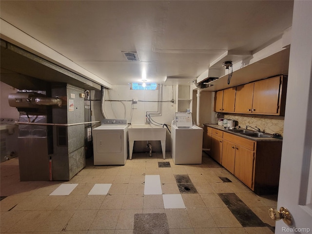 3136 Alden Dr, Sterling Heights, MI 48310 - laundry area with separate washer and dryer, light flooring, heating unit, and cabinet space